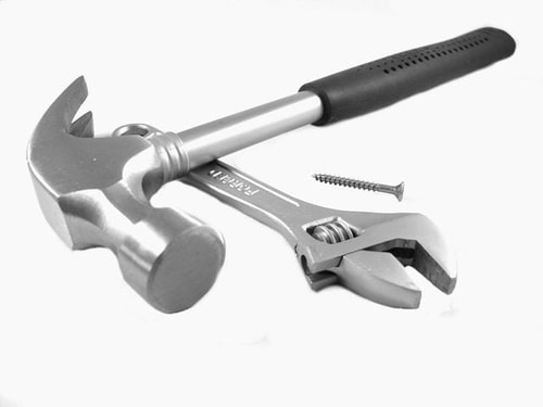 A hammer, a wrench, and a screw
